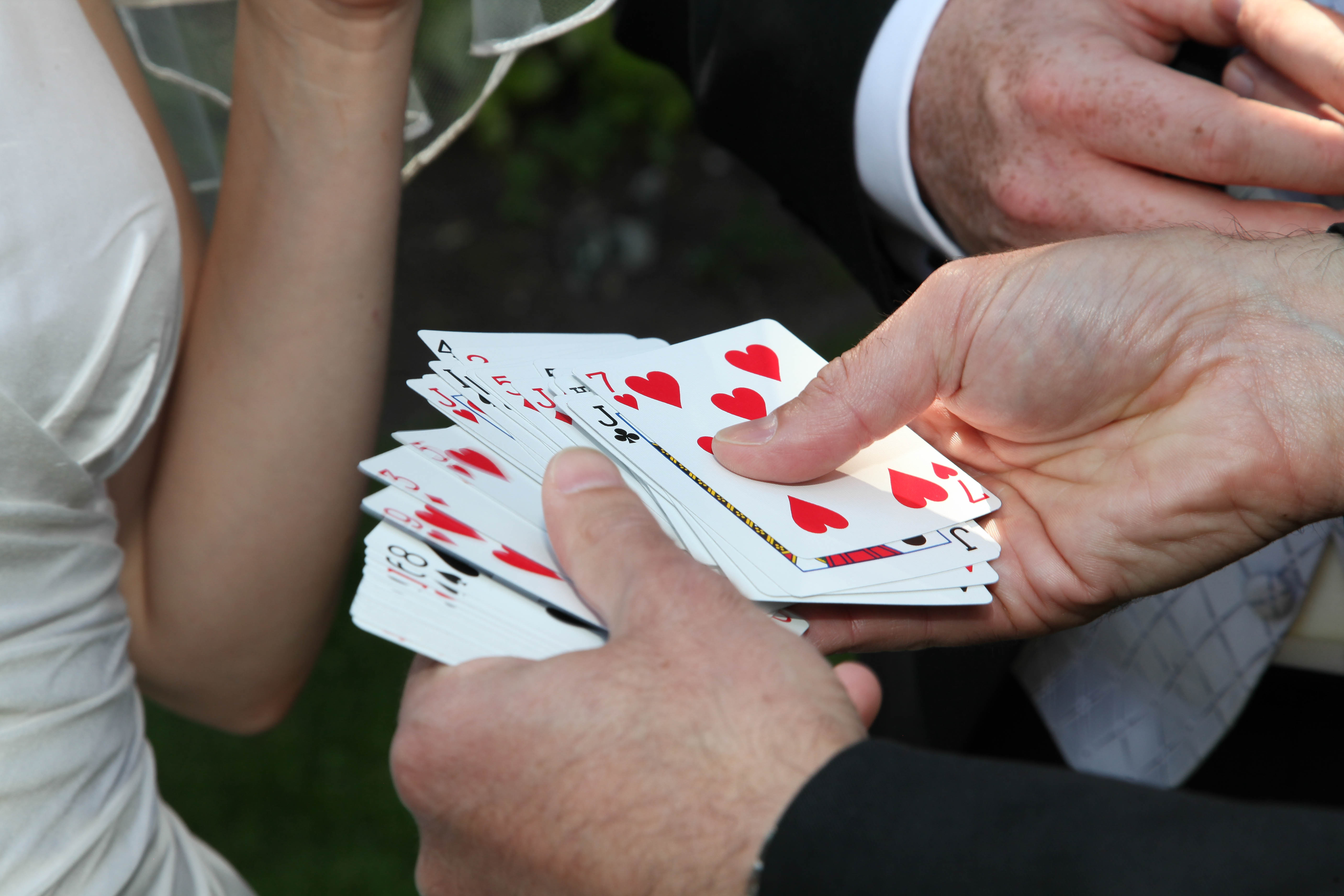 Close-Up Of Hands Spreading Playing Cards During A Magic Performance