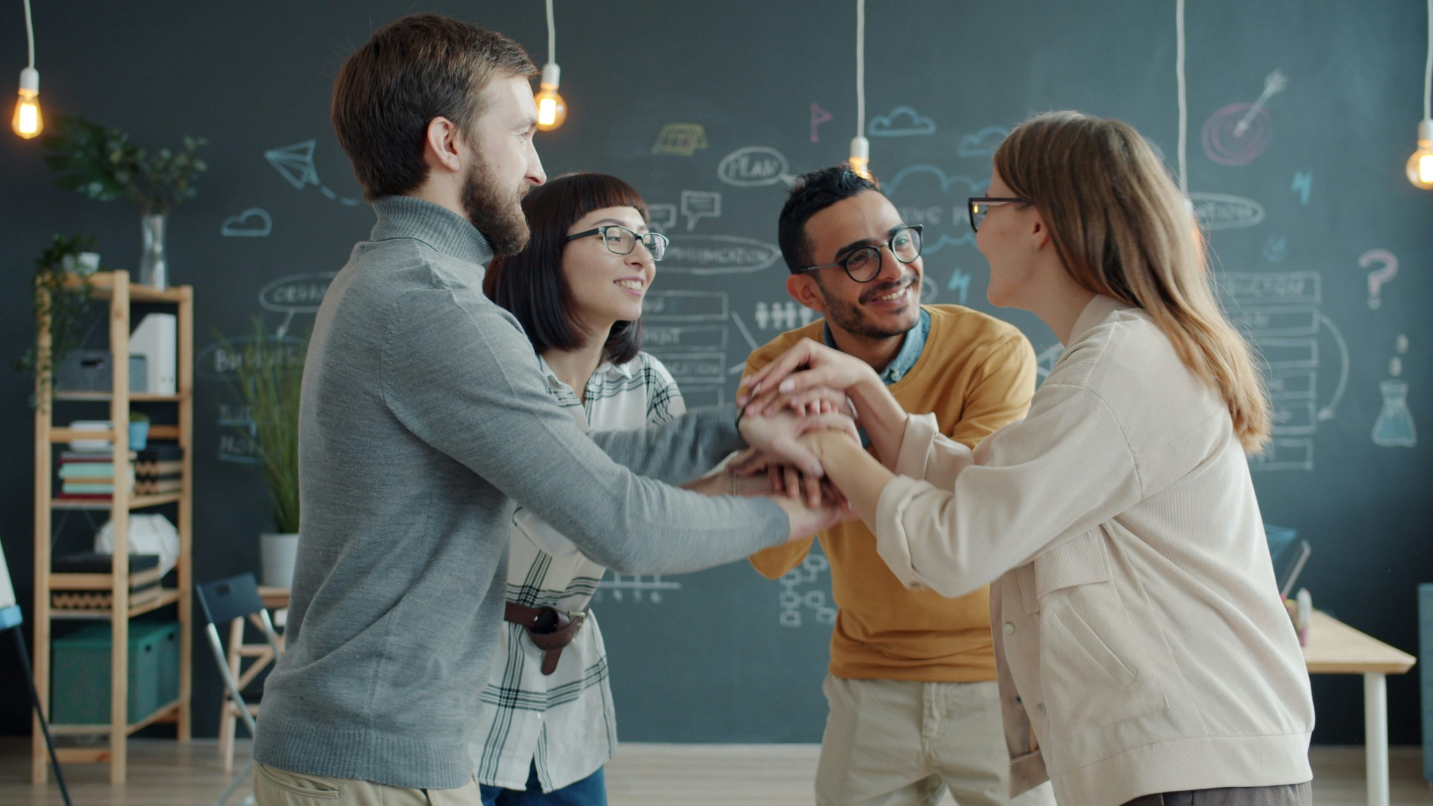 Colleagues Talking Together In A Shared Workspace